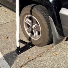 car wheel with boot on sidewalk