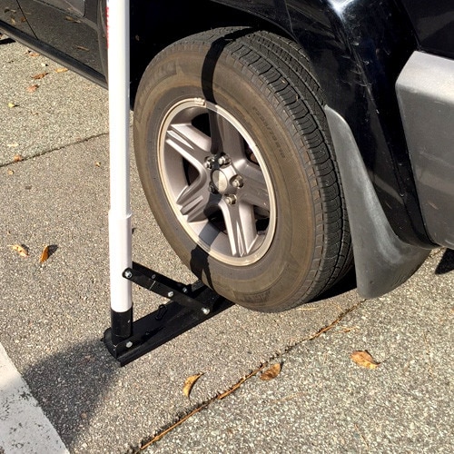 car wheel with boot on sidewalk