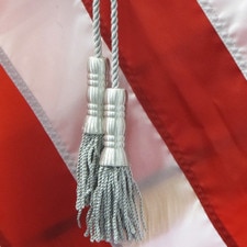 flag tassels on red background