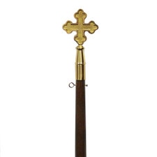 gold cross on wooden staff