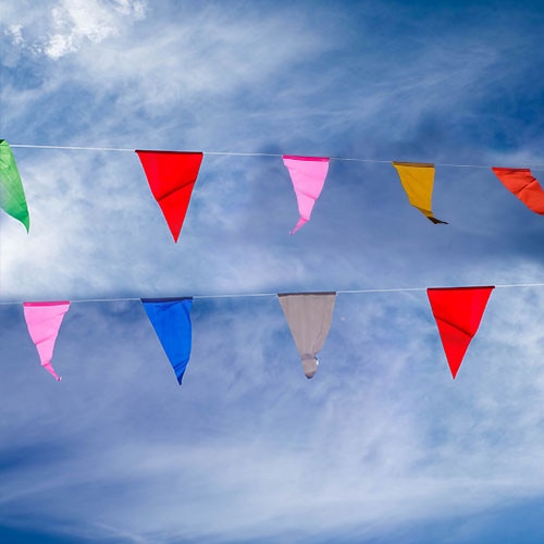 colorful flags against blue sky