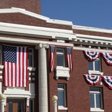 American flags on brick building