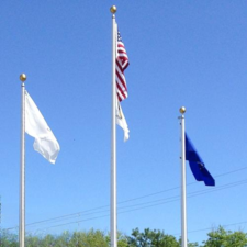 flags flying against blue sky