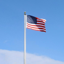 USA flag flying against blue sky