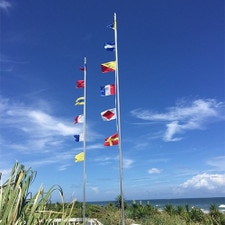 colorful flags on beach poles